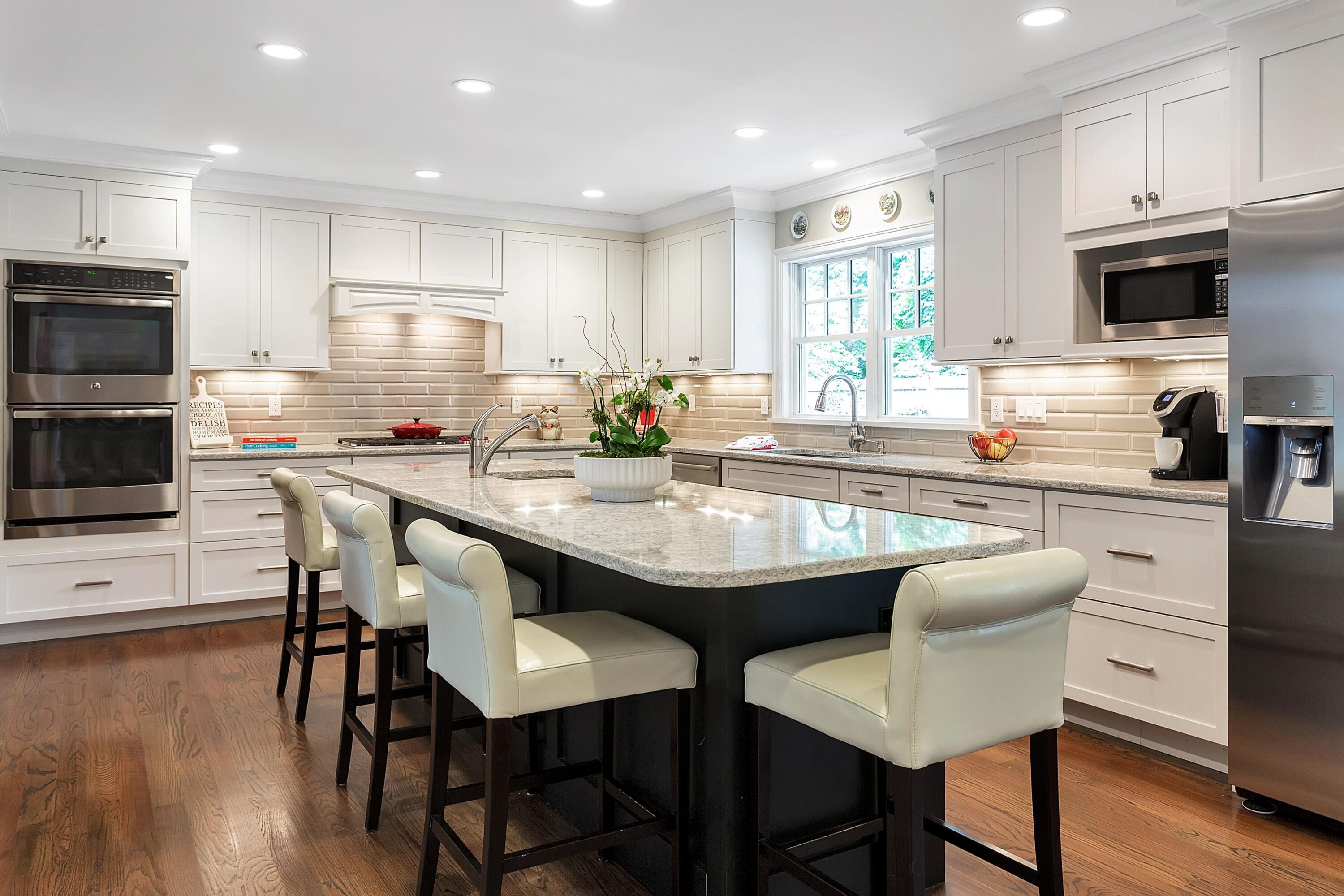 2 Cedar Gate Road Darien, CT 06820 - Photo 12 of 42 a kitchen with stainless steel appliances granite countertop a table chairs microwave and sink