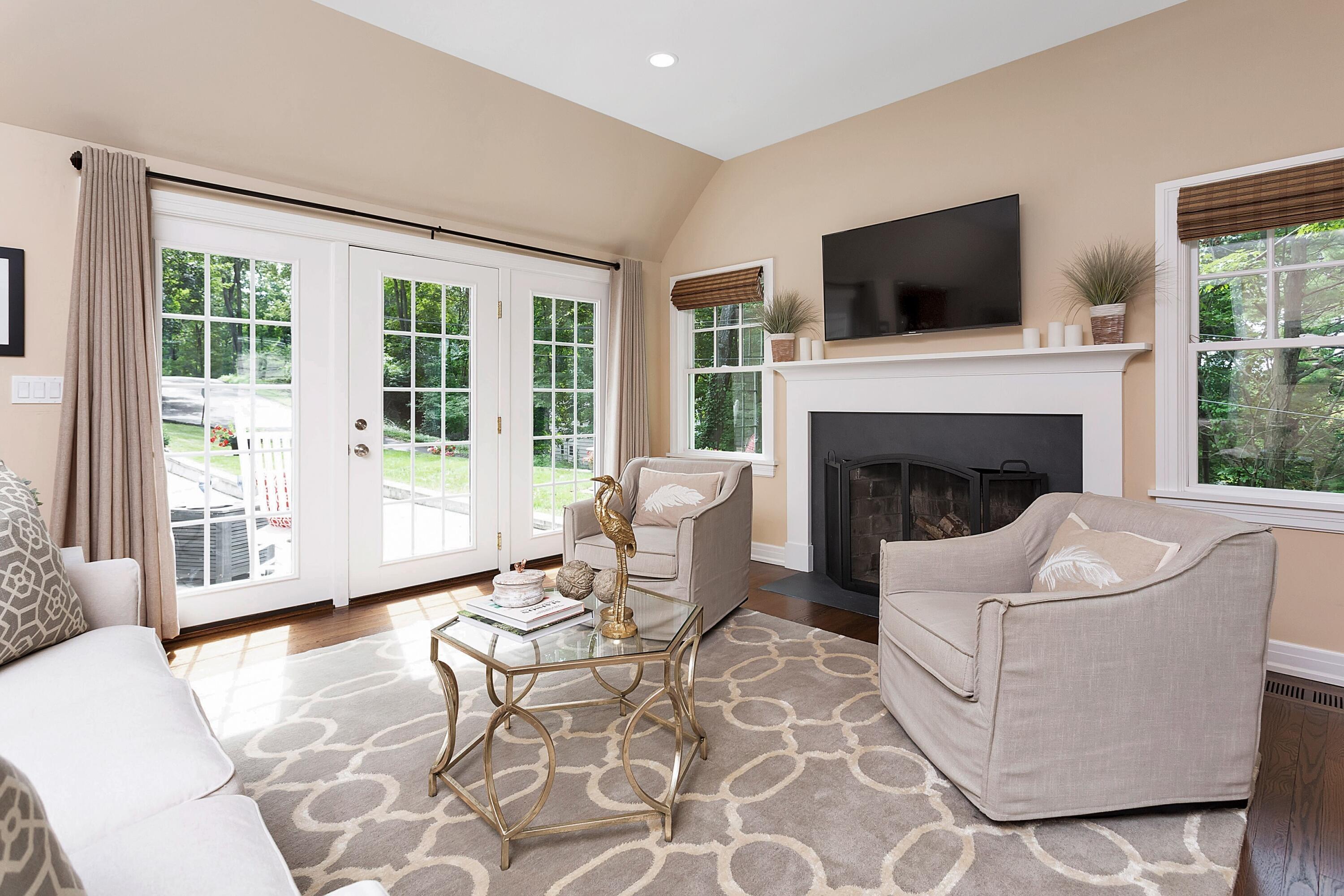 2 Cedar Gate Road Darien, CT 06820 - Photo 15 of 42 a living room with furniture a flat screen tv and a fireplace