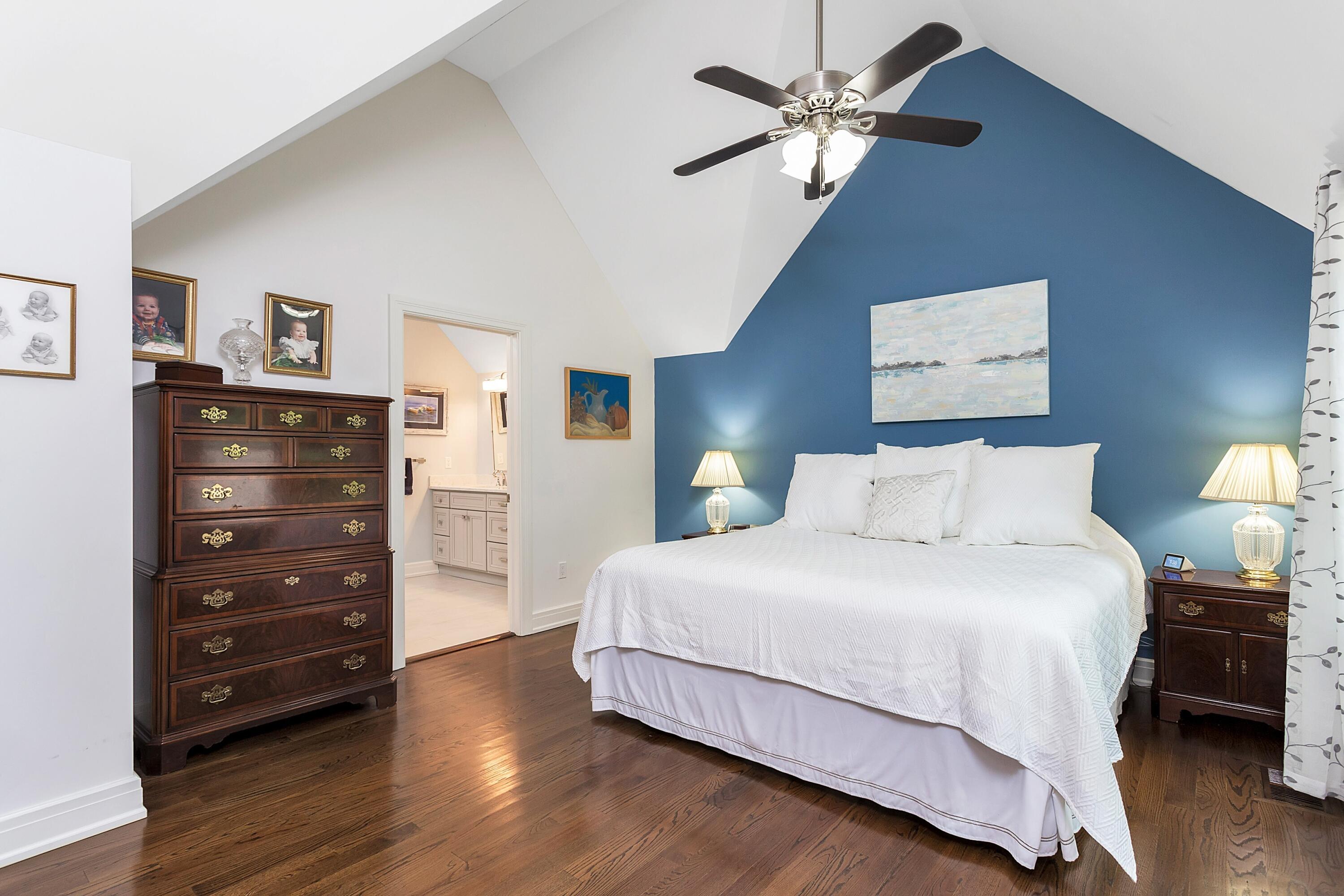 2 Cedar Gate Road Darien, CT 06820 - Photo 21 of 42 a bedroom with a bed and a chandelier