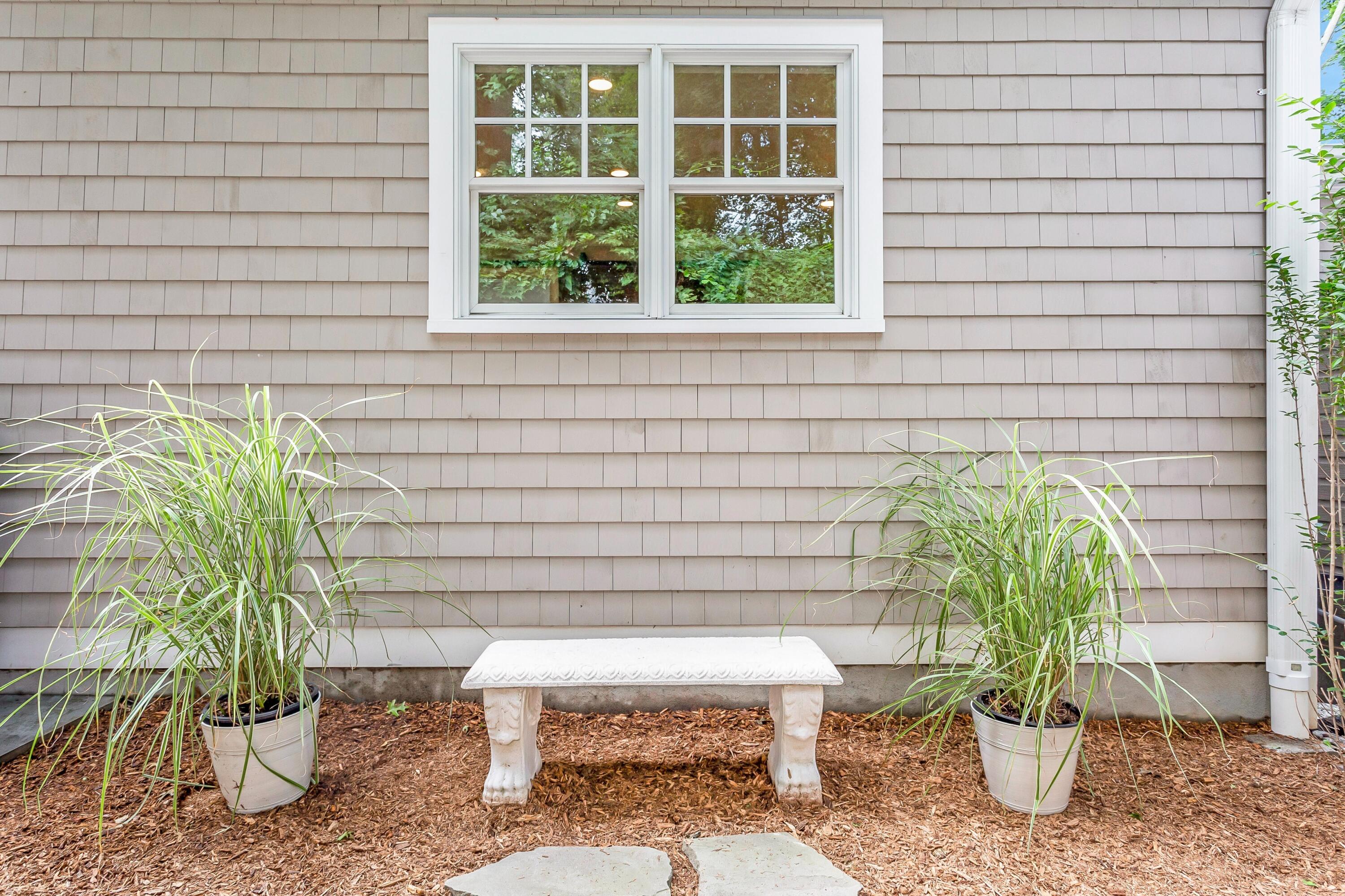 2 Cedar Gate Road Darien, CT 06820 - Photo 40 of 42 a potted plant sitting on a outside front of a house