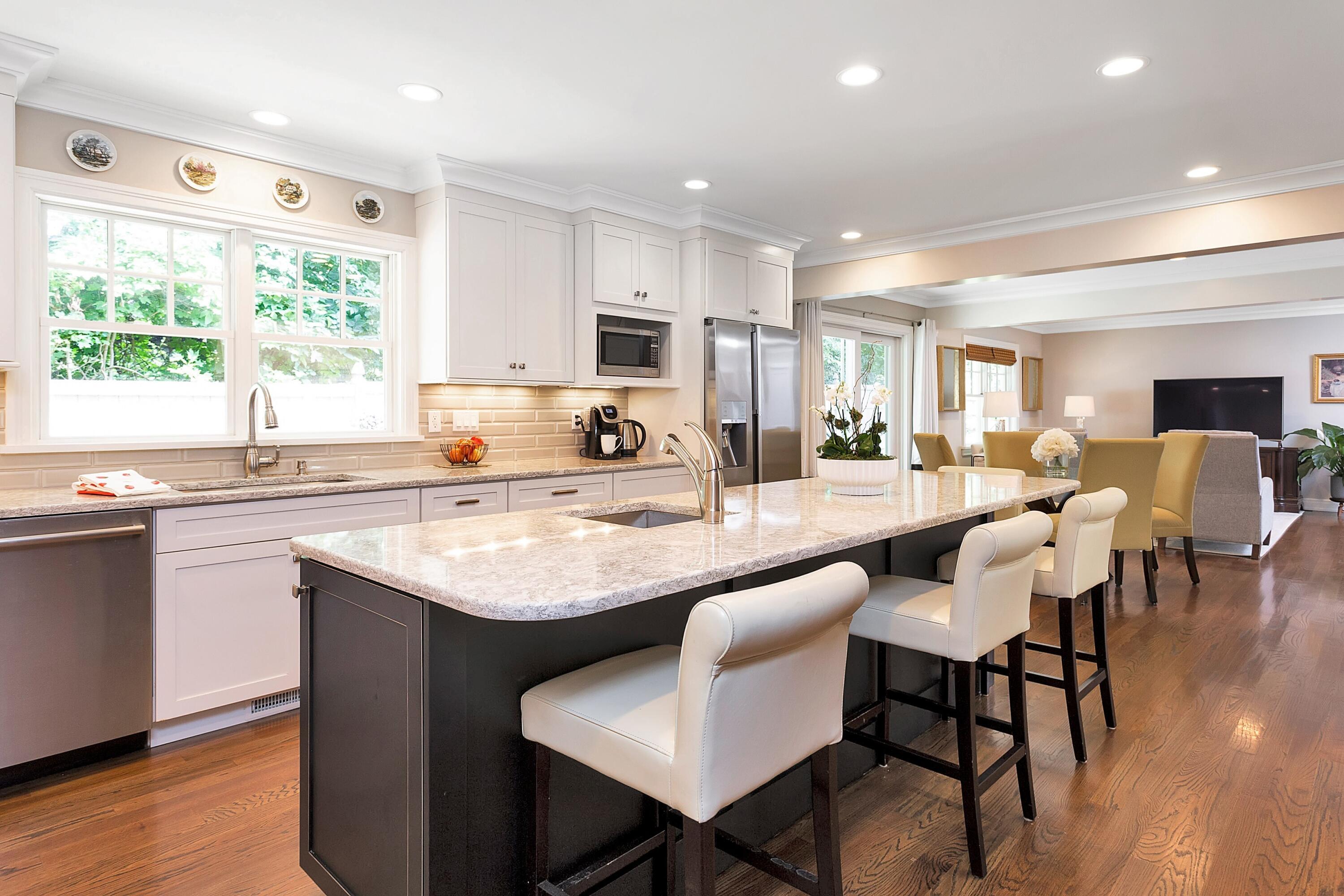 2 Cedar Gate Road Darien, CT 06820 - Photo 8 of 42 a large kitchen with kitchen island a large window in a dining table and chairs