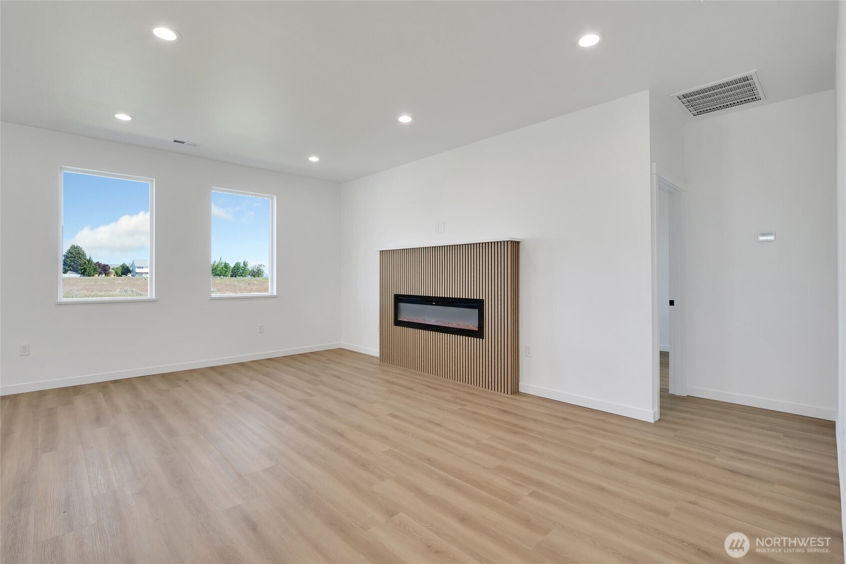 11 Parkside Loop Southeast Ephrata, WA 98823 - Photo 12 of 40 an empty room with wooden floor and windows