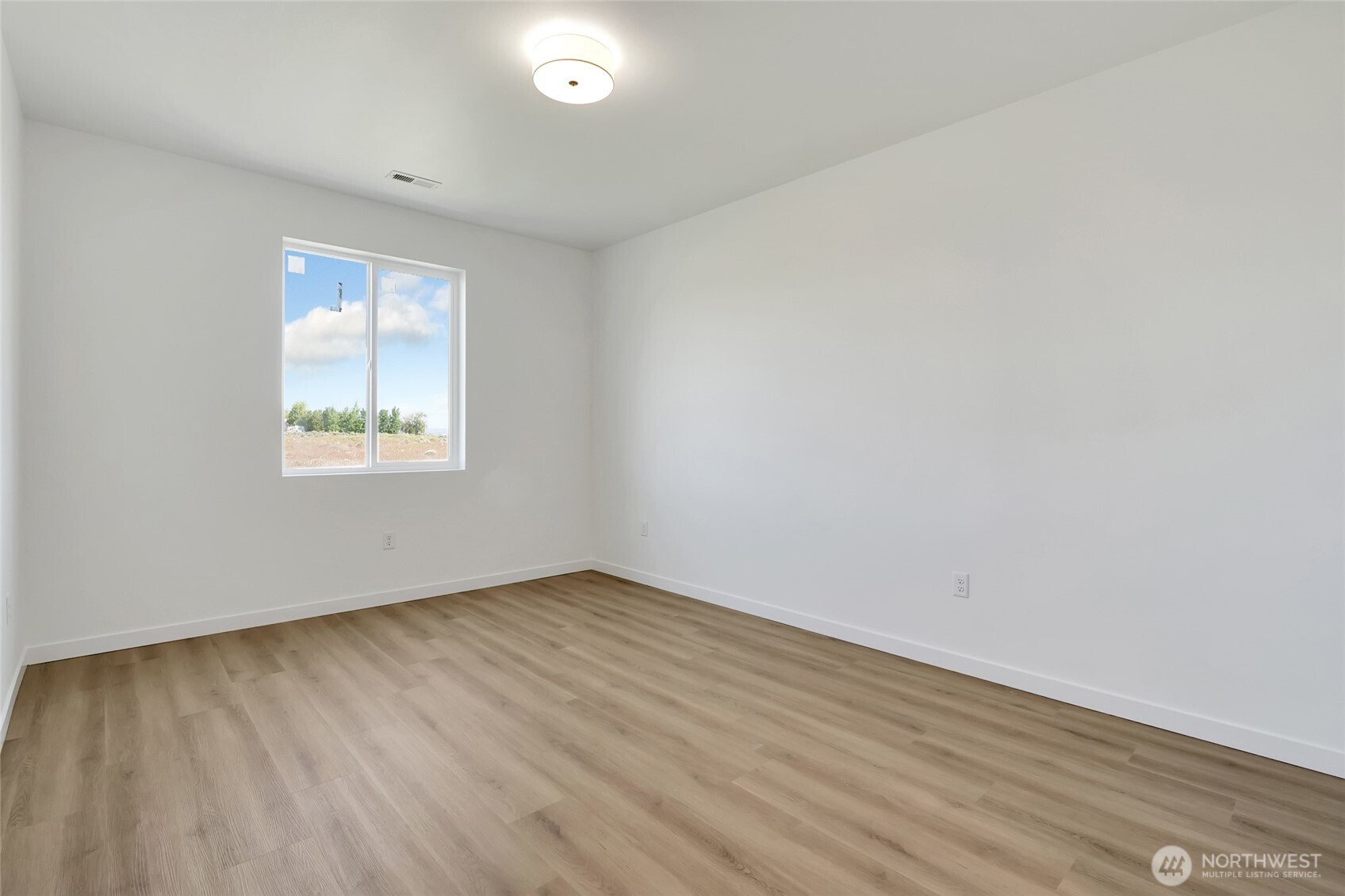 11 Parkside Loop Southeast Ephrata, WA 98823 - Photo 24 of 40 an empty room with wooden floor and windows