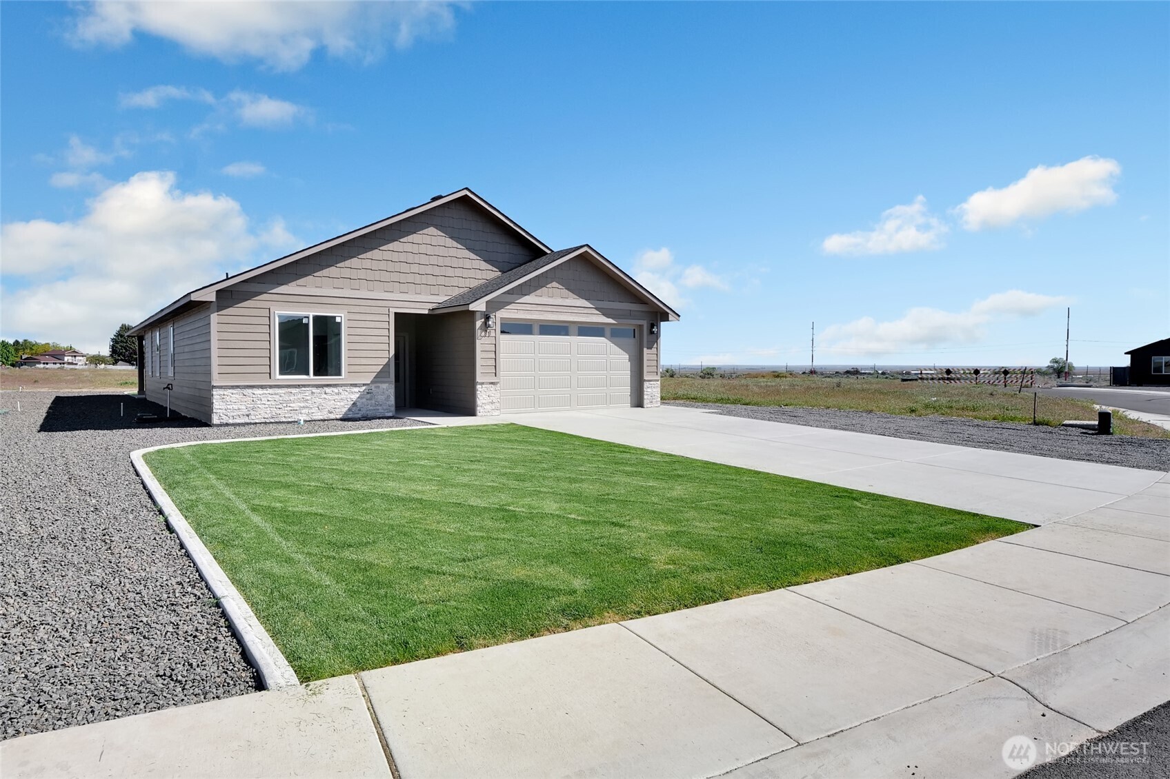 11 Parkside Loop Southeast Ephrata, WA 98823 - Photo 6 of 40 a front view of a house with a yard and trees