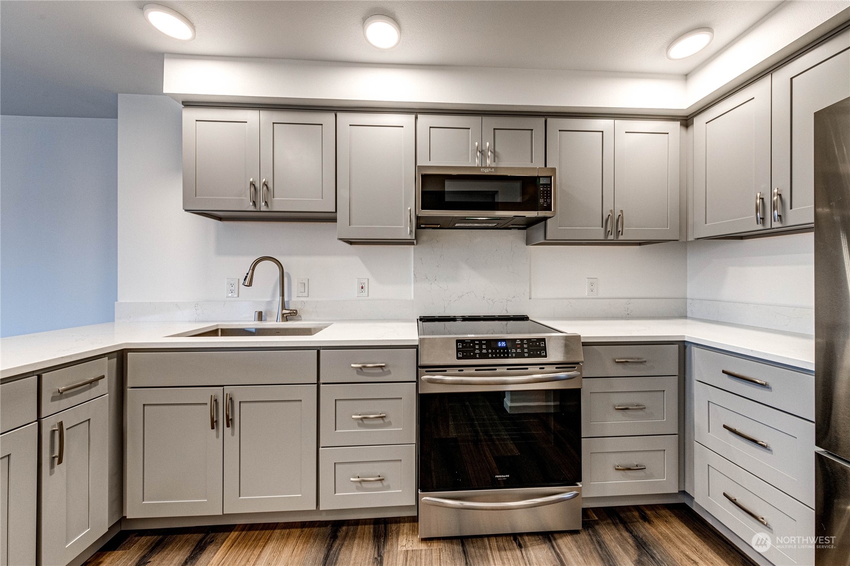 2219 Rucker Avenue, Unit 202 Everett, WA 98201 - Photo 11 of 28 a kitchen with white cabinets and appliances