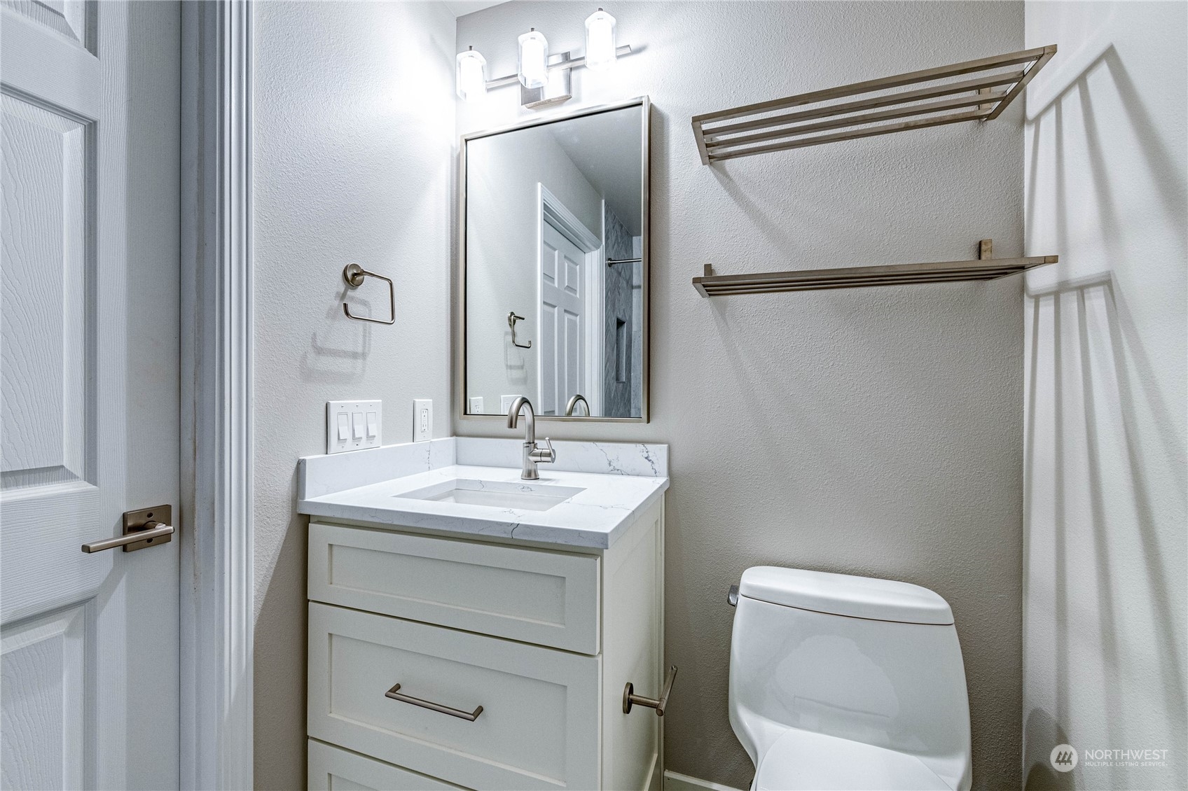 2219 Rucker Avenue, Unit 202 Everett, WA 98201 - Photo 15 of 28 a bathroom with a toilet sink vanity and mirror
