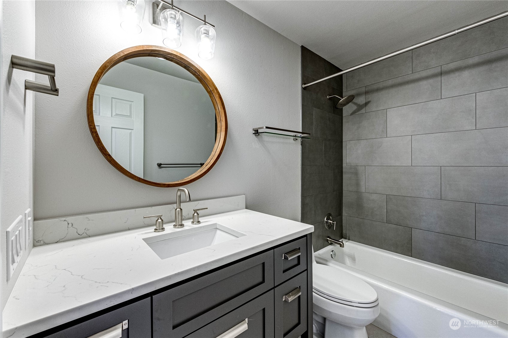 2219 Rucker Avenue, Unit 202 Everett, WA 98201 - Photo 19 of 28 a bathroom with a sink a toilet and a mirror