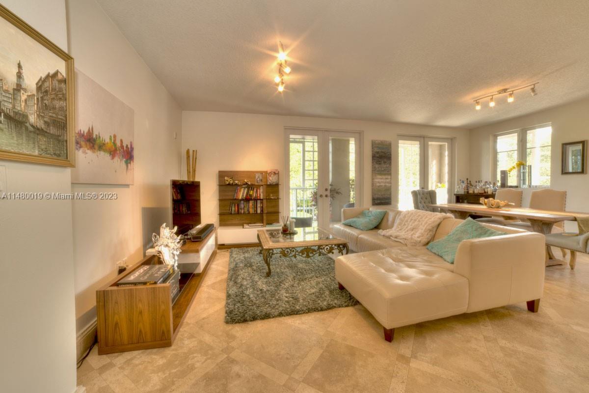 a living room with furniture and large windows