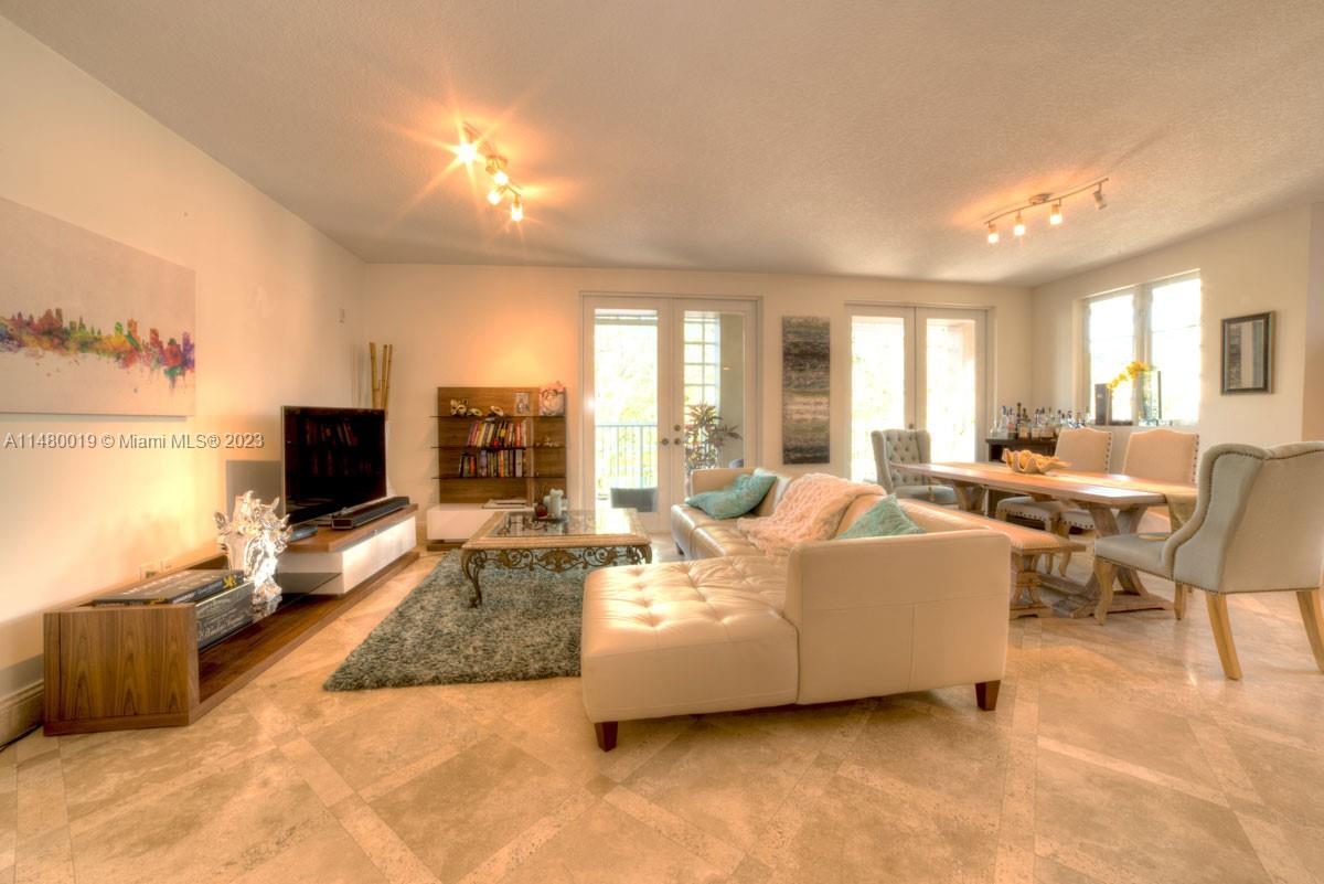 3540 Main Highway, Unit 301 Miami, FL 33133 - Photo 2 of 29 a living room with furniture and a flat screen tv