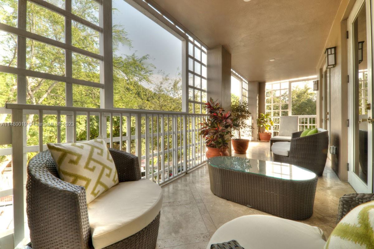 3540 Main Highway, Unit 301 Miami, FL 33133 - Photo 7 of 29 a living room with furniture and a large window