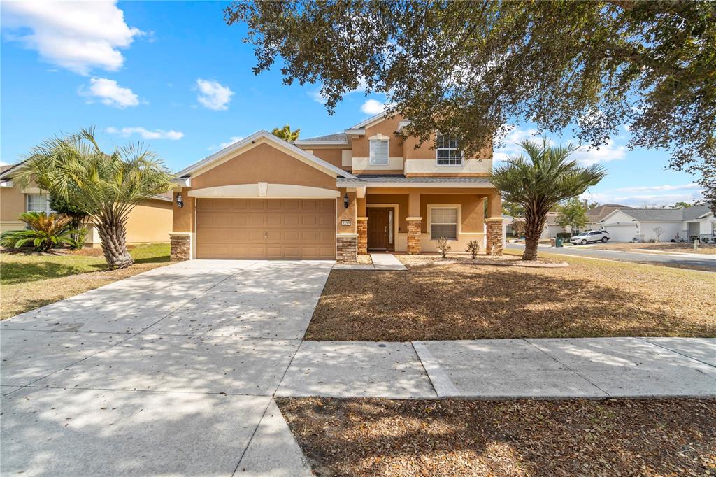 4199 Southwest 46th Court Ocala, FL 34474 - Photo 4 of 50 a front view of a house with a yard