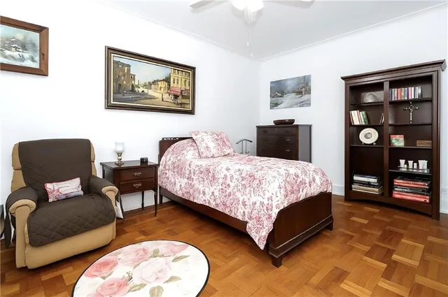 a bedroom with a bed couch and a bookshelf
