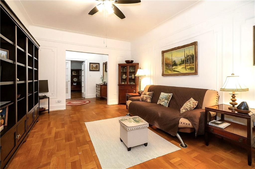 255 79th Street, Unit B4 Brooklyn, NY 11209 - Photo 4 of 23 a living room with furniture and a book shelf