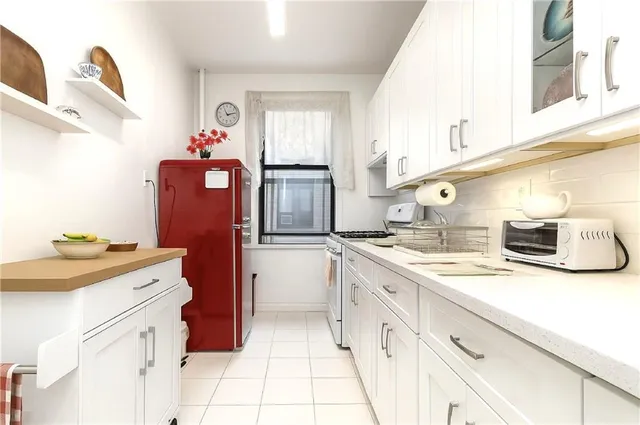 a kitchen with granite countertop a sink stove and cabinets