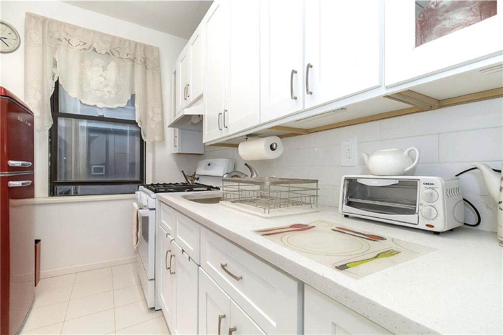 255 79th Street, Unit B4 Brooklyn, NY 11209 - Photo 7 of 23 a kitchen with a sink stove and cabinets