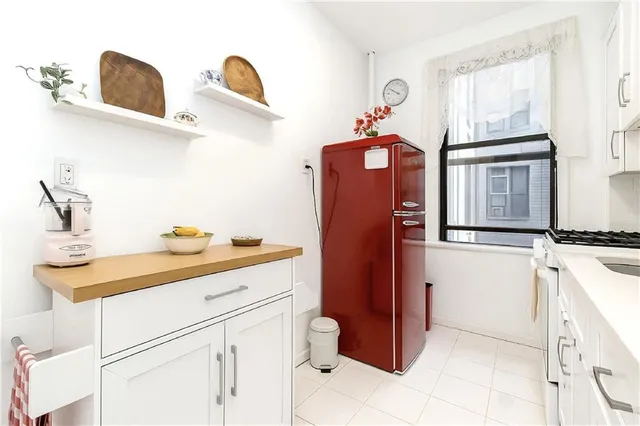 a kitchen with stainless steel appliances a sink and cabinets