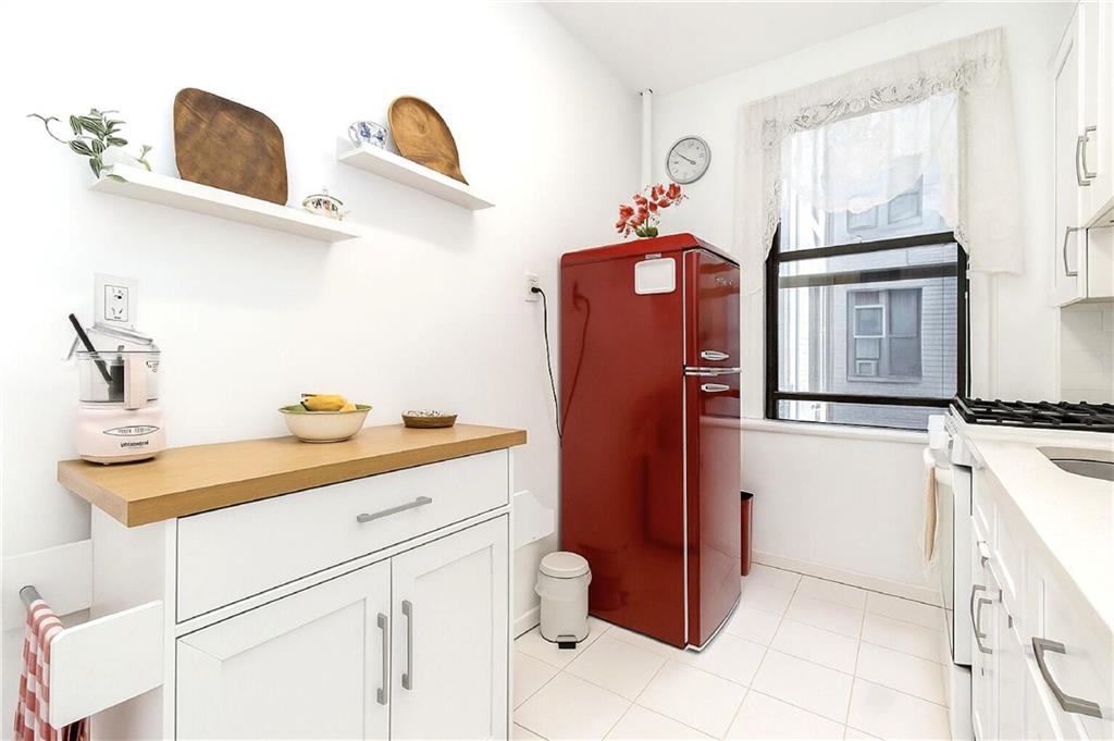 255 79th Street, Unit B4 Brooklyn, NY 11209 - Photo 8 of 23 a kitchen with stainless steel appliances a sink and cabinets