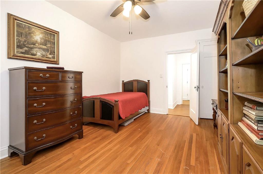 255 79th Street, Unit B4 Brooklyn, NY 11209 - Photo 9 of 23 a bedroom with a bed and a chandelier