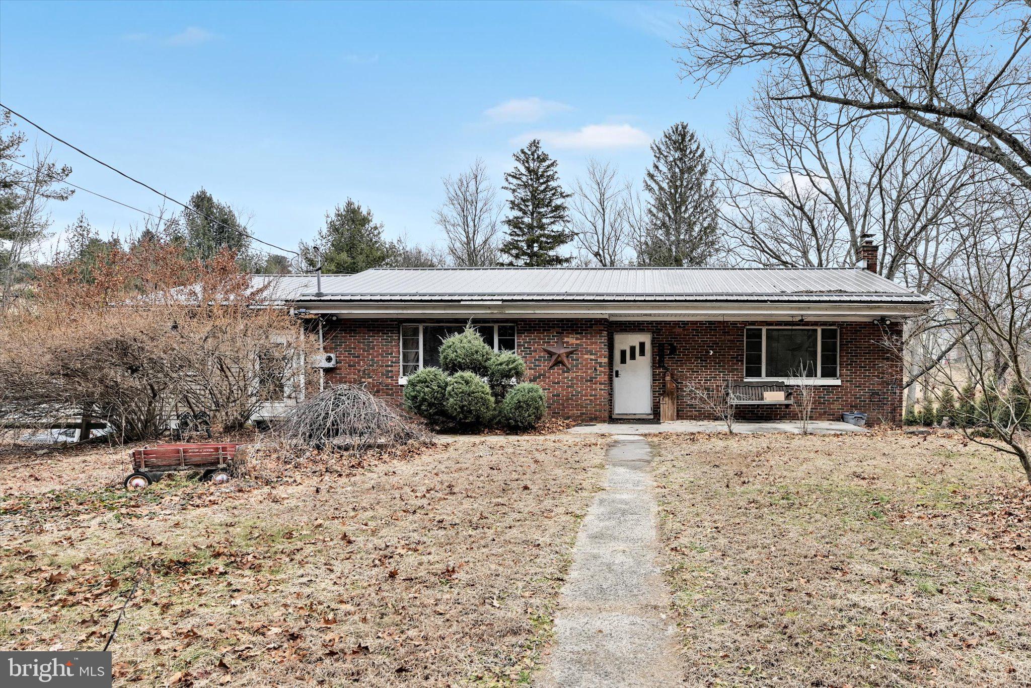 a front view of a house with a yard and trees