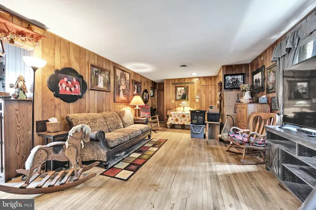 a living room with furniture a rug and a flat screen tv
