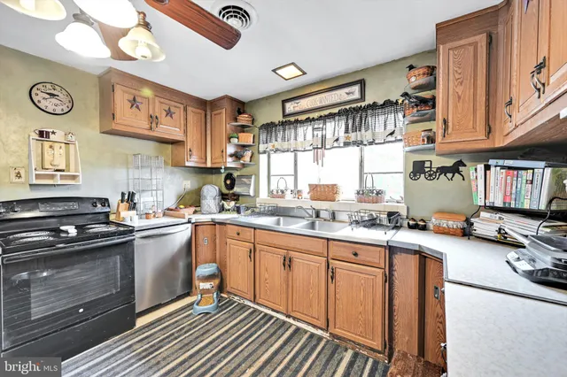 a kitchen with stainless steel appliances granite countertop a sink stove and cabinets