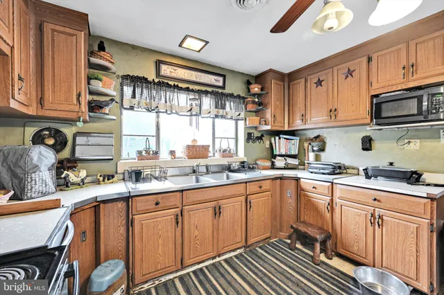 a kitchen with stainless steel appliances granite countertop a stove sink and cabinets