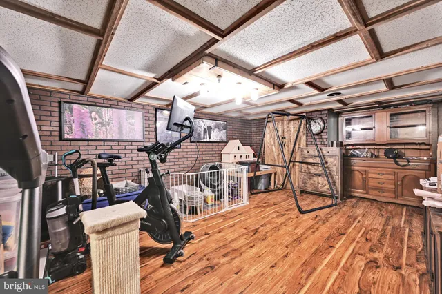 a view of a livingroom with furniture hardwood and floor to ceiling window