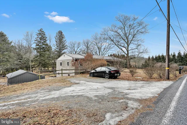 a view of a house with snow in front of house