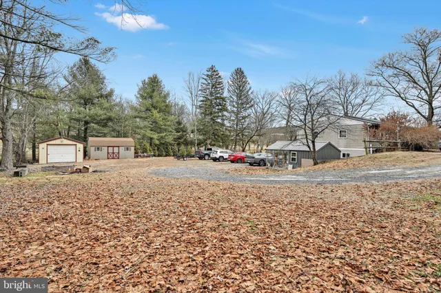 a view of a white house with a yard