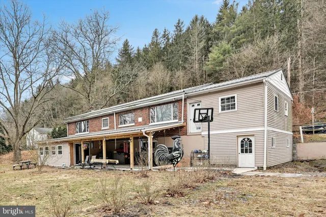 a view of a house with a yard covered in snow