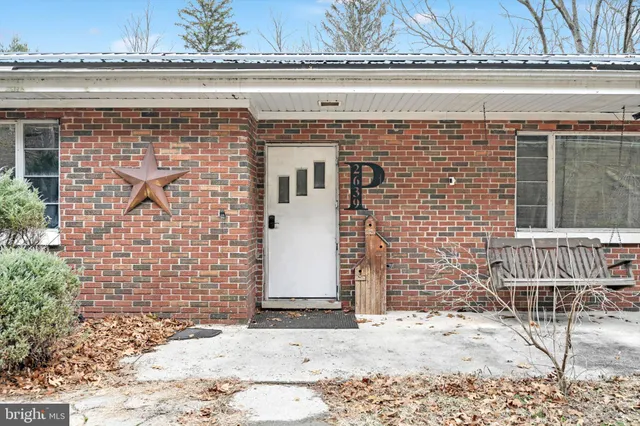 a front view of a house with a wall