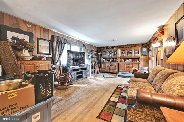a living room with furniture a fireplace and large windows