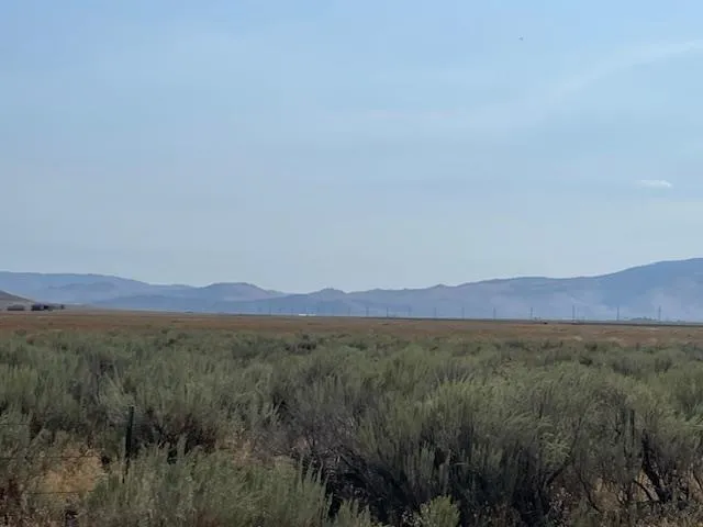 a view of a town with mountains in the background