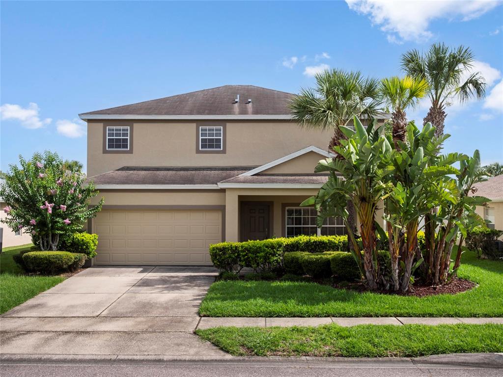 512 Bella Rosa Circle Sanford, FL 32771 - Photo 1 of 31 a front view of a house with a yard and potted plants