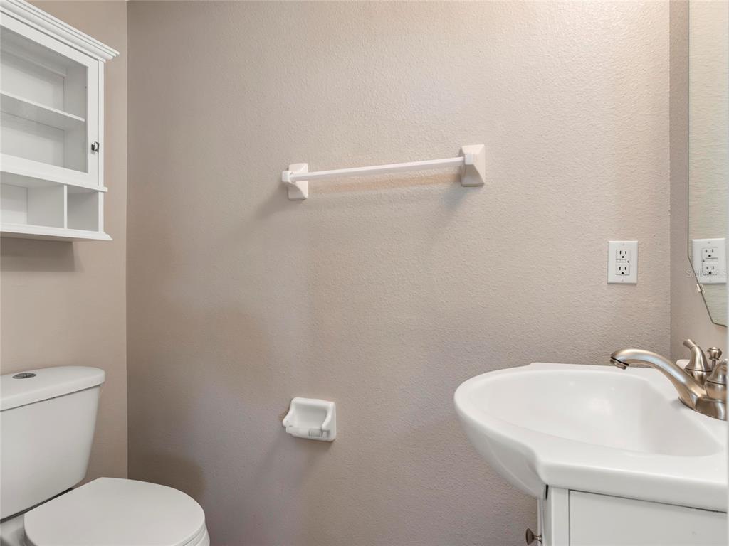 512 Bella Rosa Circle Sanford, FL 32771 - Photo 14 of 31 a bathroom with a toilet sink and mirror