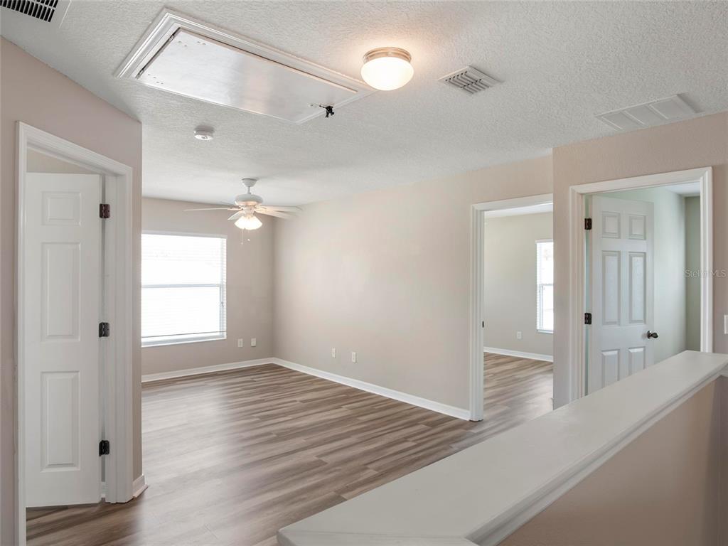 512 Bella Rosa Circle Sanford, FL 32771 - Photo 17 of 31 wooden floor in an empty room with a window