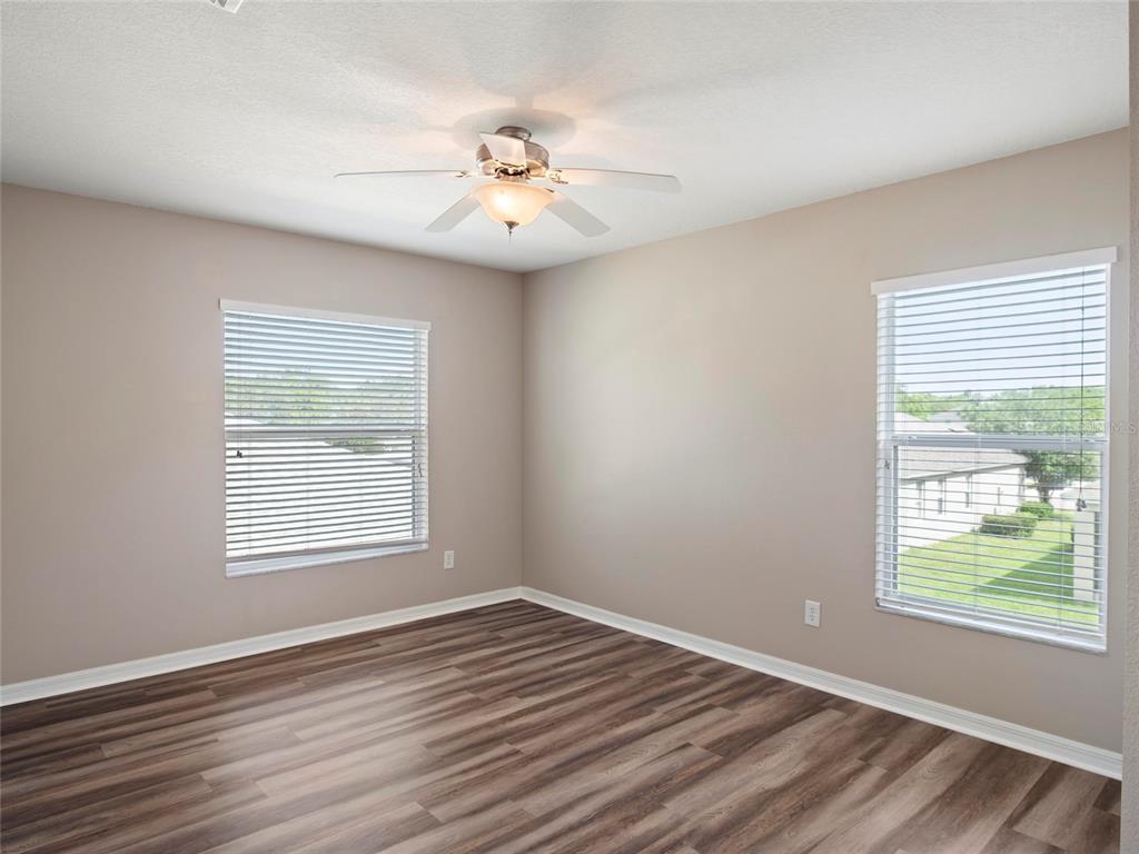 512 Bella Rosa Circle Sanford, FL 32771 - Photo 18 of 31 a view of an empty room with wooden floor and a window