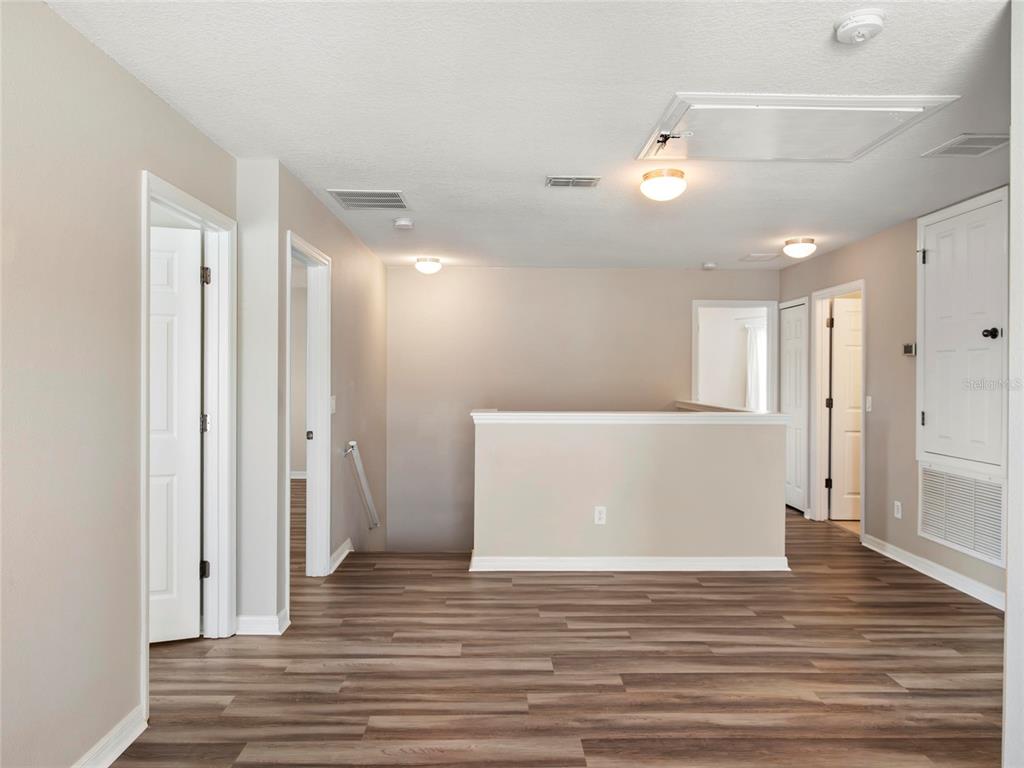 512 Bella Rosa Circle Sanford, FL 32771 - Photo 19 of 31 a view of a room with wooden floor and a ceiling fan