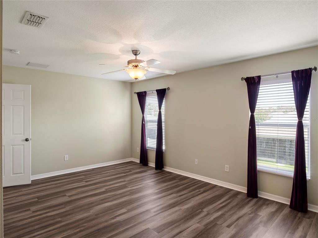 512 Bella Rosa Circle Sanford, FL 32771 - Photo 20 of 31 a view of an empty room with wooden floor and a window