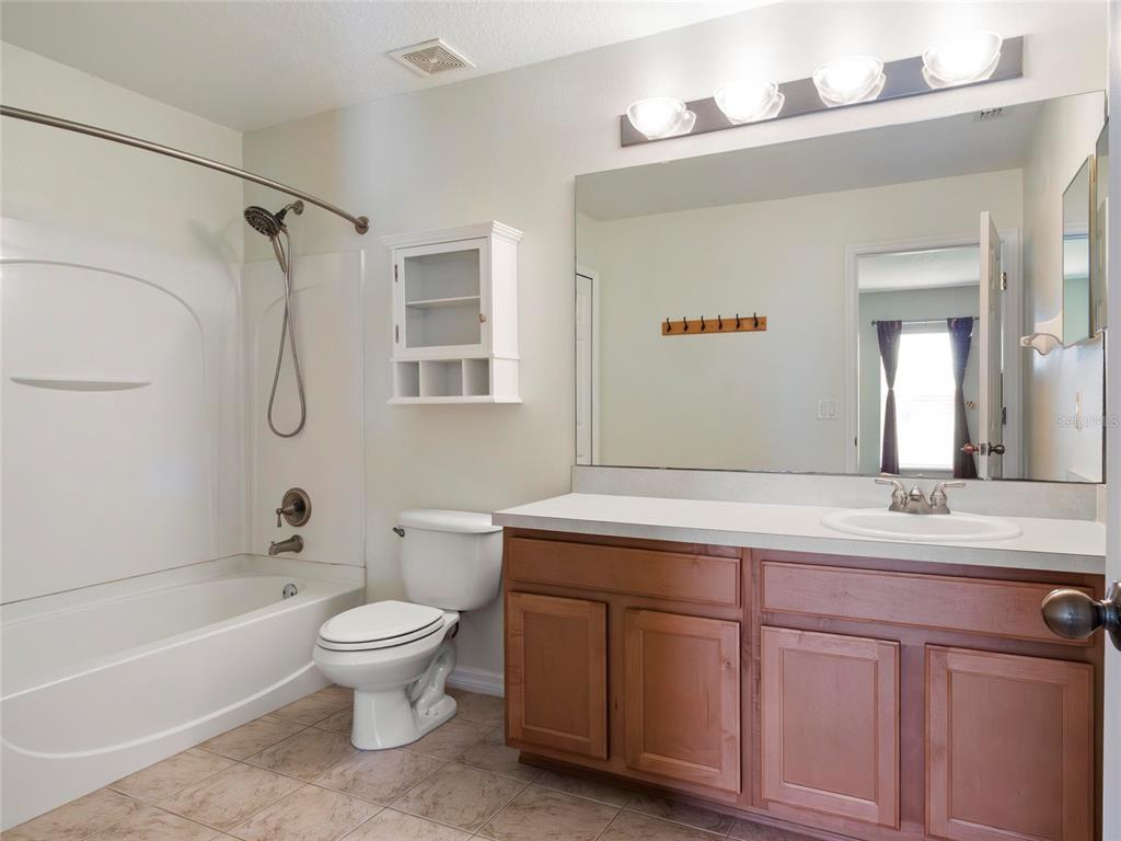 512 Bella Rosa Circle Sanford, FL 32771 - Photo 22 of 31 a bathroom with a sink a toilet and shower