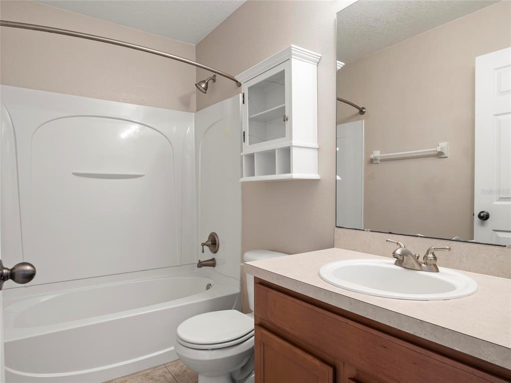 512 Bella Rosa Circle Sanford, FL 32771 - Photo 26 of 31 a bathroom with a granite countertop sink toilet and shower