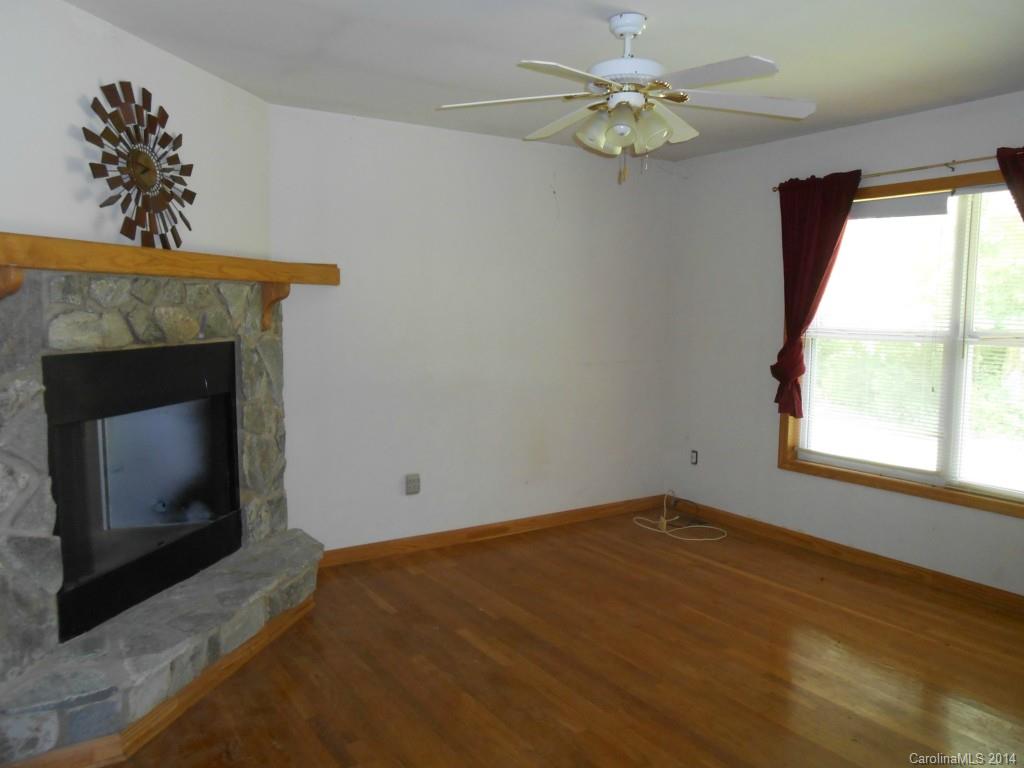 1883 Potter Road Lancaster, SC 29720 - Photo 2 of 17 a view of empty room with fireplace and fan