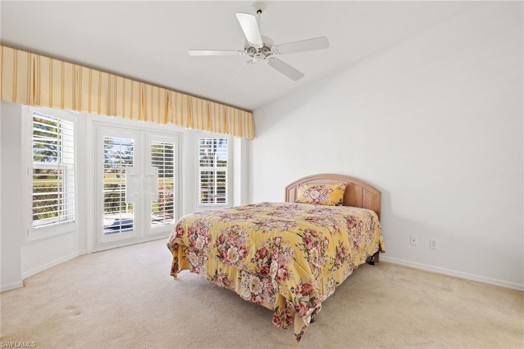 8526 Mustang Drive Naples, FL 34113 - Photo 11 of 24 Bedroom with access to exterior, multiple windows, and carpet flooring