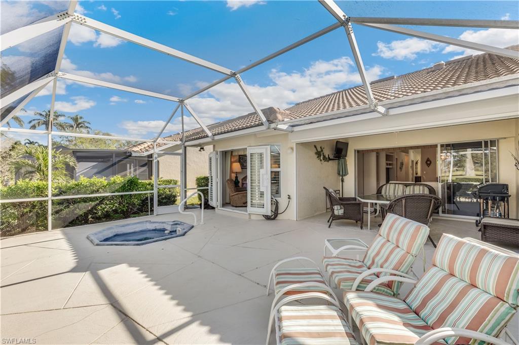 8526 Mustang Drive Naples, FL 34113 - Photo 16 of 24 View of patio / terrace featuring outdoor lounge area, a lanai, and an outdoor hot tub