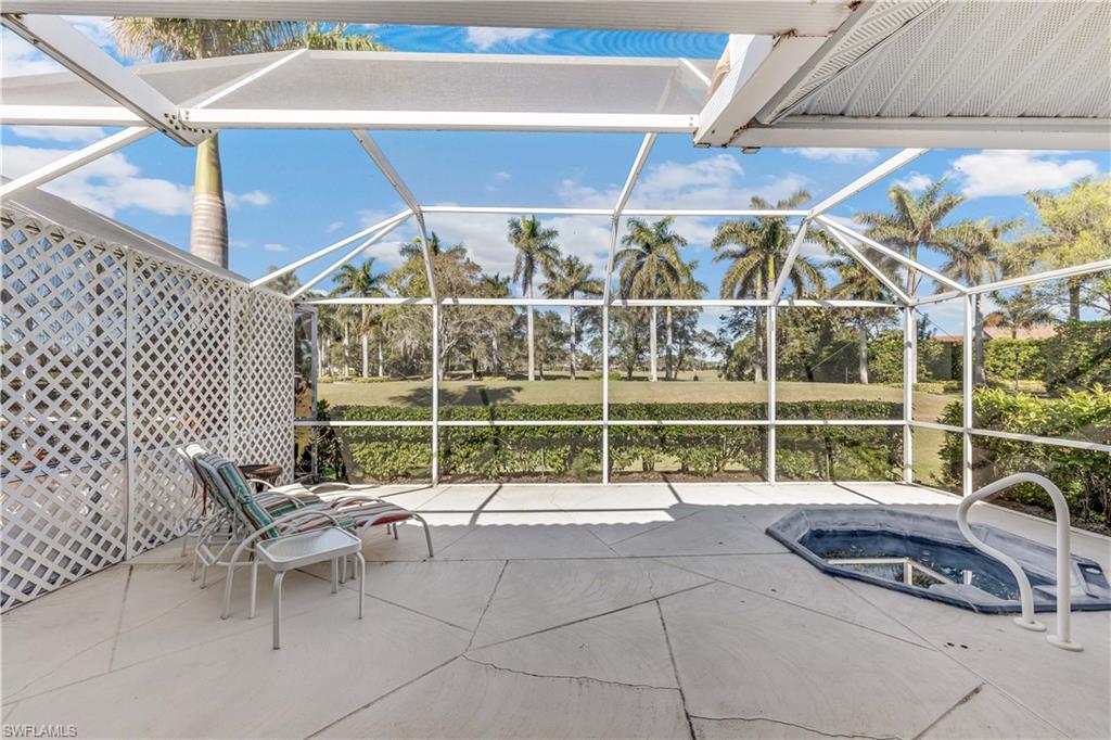 8526 Mustang Drive Naples, FL 34113 - Photo 17 of 24 View of patio / terrace featuring glass enclosure and a jacuzzi