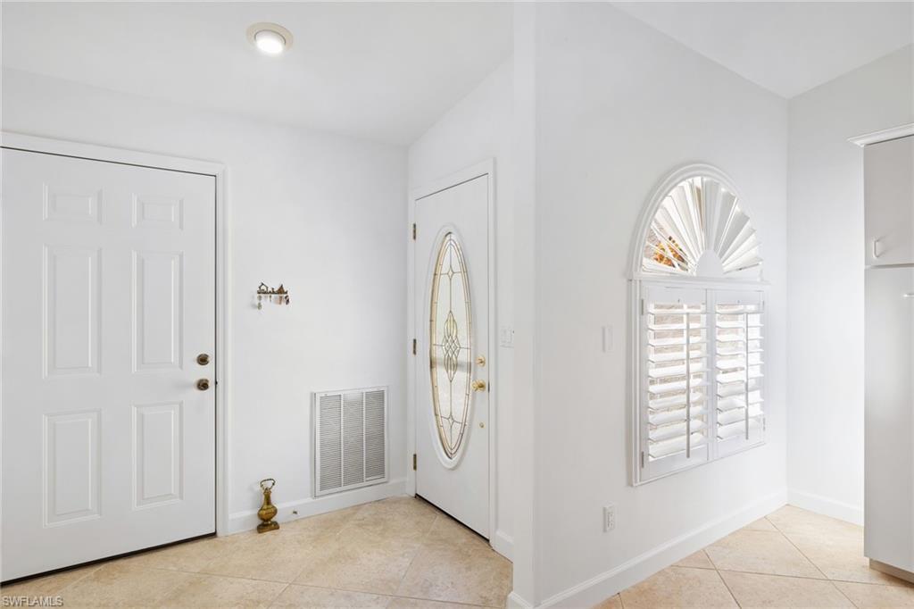 8526 Mustang Drive Naples, FL 34113 - Photo 2 of 24 Entryway with visible vents, baseboards, and light tile patterned flooring
