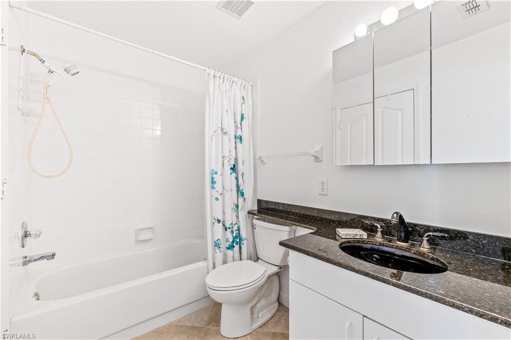 8526 Mustang Drive Naples, FL 34113 - Photo 10 of 24 Full bathroom with tile patterned flooring, vanity, toilet, and shower / tub combo with curtain