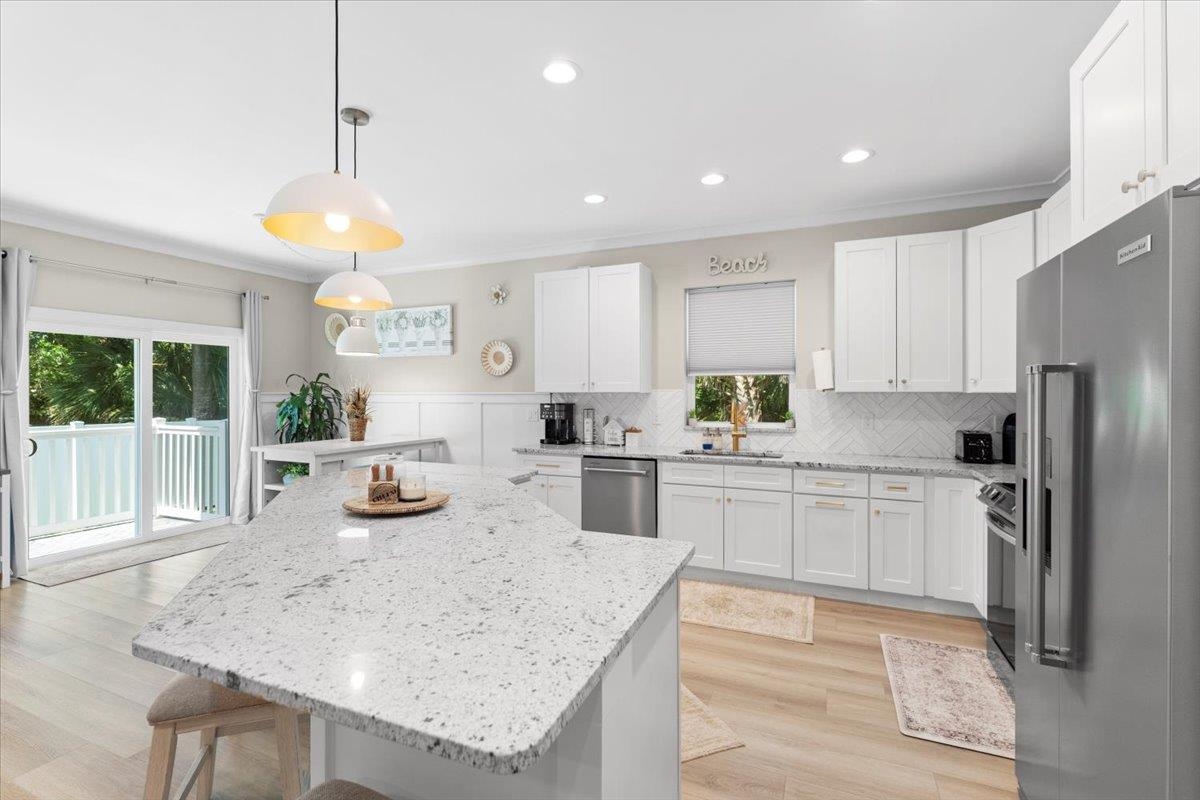 633 West Pope Road St. Augustine, FL 32080 - Photo 12 of 42 a kitchen with sink cabinets and refrigerator