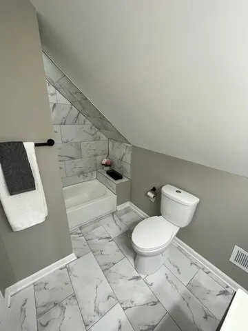 a bathroom with a toilet and a sink