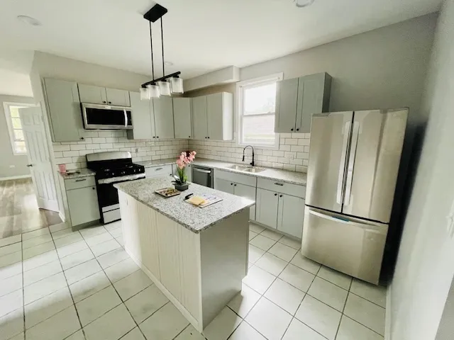 a kitchen with appliances cabinets and a sink
